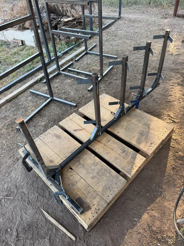Saddle rack frames clamped to a pallet jig in the yard while they are welded